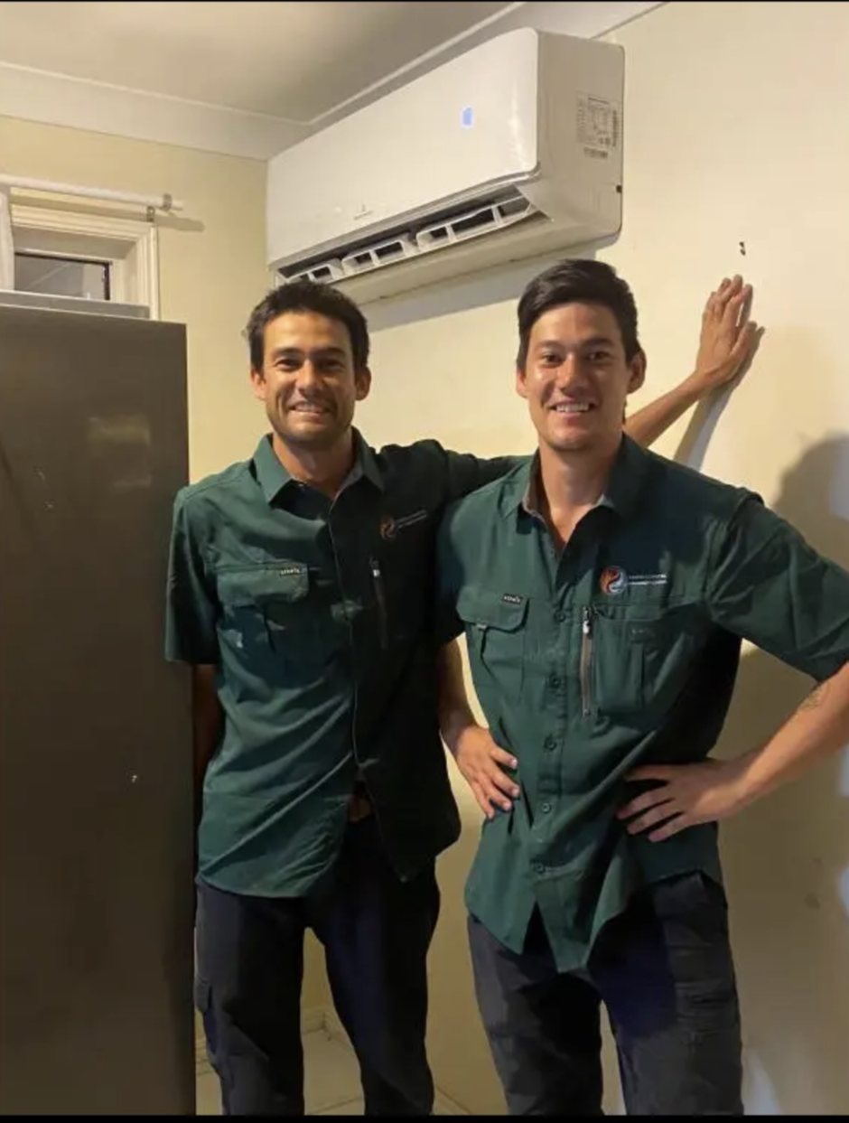 Zen and Kai of Kaizen Coastal Air Conditioning beneath a newly installed split-system air conditioner